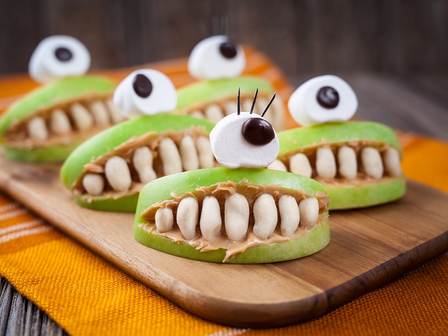 Spooky halloween edible apple monsters healthy natural dessert. Horror party